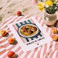 Pollo al Ajillo – on Striped Tablecloth, Spanish Food Wall Art, unframed on coastal sand