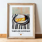 Tarta de Santiago – on Striped Tablecloth, Spanish Dessert Illustration, in wooden frame leaning on the floor