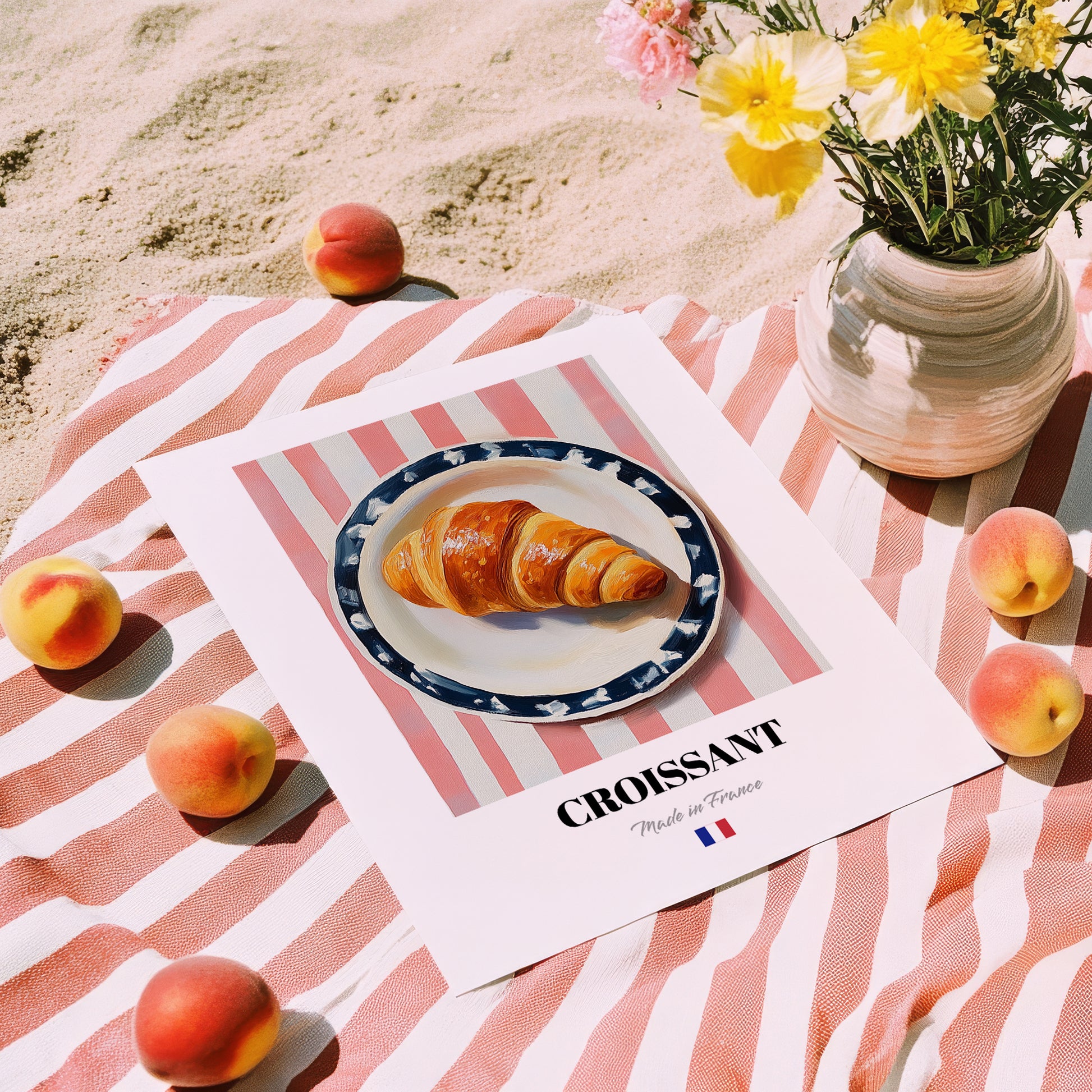 Croissant – on Striped Tablecloth, French French Pastry Wall Art, unframed on coastal sand