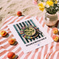 Avgolemono Soup – on Striped Tablecloth, Greek Food Wall Decor, unframed on coastal sand