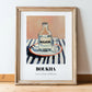 Boukha – on Striped Tablecloth, Tunisian Wine Still Life, in wooden frame leaning on the floor