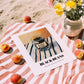 Black Beans – on Striped Tablecloth, Dry Goods Wall Art, unframed on coastal sand