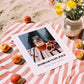 Pomegranate Juice – on Striped Tablecloth, Lemonade Art, unframed on coastal sand