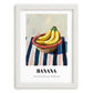 Banana – on Striped Tablecloth, Fruit Wall Decor, placed in minimal white frame