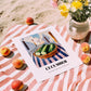 Cucumber – White village Urban Café Scene, Vegetable Poster, unframed on coastal sand
