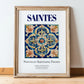 Saintes, France – Travel Poster, in wooden frame leaning on the floor
